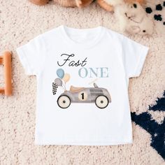 Fast One Birthday Shirt, First Birthday Shirt, Race Car Birthday Shirt, Birthday Boy Shirt, First Birthday Shirt, Race Car Birthday 💗  Welcome to The WildflowerbyMiley Etsy Shop!  This listing is for the bodysuit, sweatshirt or t-shirt only. All other items that are shown in our photos such as shoes, hats, beanies, blankets etc. are for photo staging purposes and are NOT INCLUDED in the sale. DESCRIPTION:  This baby and children's unisex essential fits like a well-loved favorite. Super soft t-s 1st Birthday Boy Race Car Theme, Fast One Birthday Party, 1st Birthday Boy Themes, Race Car Themes, First Birthday Shirt, Birthday Boy Shirt, One Year Birthday, Cars Theme Birthday Party, Birthday Themes For Boys