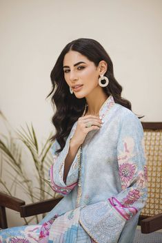 An Uber cool Ice blue ombré in-house printed raw silk shirt and dupatta. All feminine details of Pearls all over the shirt with hand-worked buttons. Our signature sleeve hem style is finished with pearl tassels and our in-house embroidered fabric. The daman is beautifully done with our appliquéd in-house embroidery. Printed dupatta in cool refined colors is finished off with laces and plain pants. Cotton Silk Traditional Wear With Embroidered Sleeves, Traditional Cotton Silk Wear With Embroidered Long Sleeves, Traditional Wear With Embroidered Long Sleeves In Cotton Silk, Cotton Silk Kurta With Embroidered Sleeves, Long Sleeve Cotton Silk Kurta With Embroidered Sleeves, Long Sleeve Cotton Silk Salwar Kameez, Unstitched Cotton Silk Kurta With Embroidered Sleeves, Designer Wear Blouse With Printed Motifs, Designer Long Sleeve Sets With Dupatta