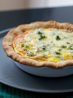 a quiche with cheese and broccoli in a bowl