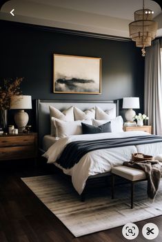 a bedroom with black walls and white bedding