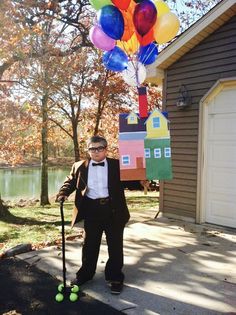 a man in a tuxedo with balloons attached to his head