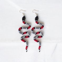 These handmade Scarlet Kingsnake Beaded Earrings are a striking statement piece inspired by the bold patterns of the scarlet kingsnake. Featuring intricate beadwork in red, black, and white, these unique earrings capture the beauty of nature and bring a bold, stylish touch to any outfit. Perfect for those who love snake-inspired jewelry, these earrings offer a blend of boho style and artistic craftsmanship. Whether as a standout accessory for yourself or a special gift for her, these earrings ar Beaded Snake, Earrings Snake, Beadwork Earrings, Special Gifts For Her, Snake Earrings, Christmas Deals, Earrings Red, Inspired Jewelry, White Beads