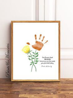 a hand print with a yellow flower on it