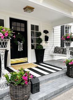 the front porch is decorated in black and white