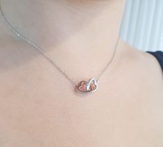 One of the most romantic necklaces. Two Hearts united together. Interlocking Heart Charms deigned with tiny CZ diamonds connected a dainty sterling silver chains. Chain and charms are 925 sterling silver. Chain length 16" and adjustable to 18". Check out my Necklaces section: https://www.etsy.com/shop/MoonliSilverDesigns?section_id=14862732 ► Nickel Free ✔ ► Tarnish Resistant ✔ ► No Allergic reaction ✔ ► 30 days return policy ✔  ► Accept replacements and custom orders ✔ ► I ship all items in a jewelry gift box ✔ ► Greeting card - upon request ✔  Shipping information : ► Tracking number ✔ ► Expedited / Express shipping - additional payment ooooooooooo ► My Shop: https://www.etsy.com/shop/MoonliSilverDesigns  ooooooooooo Please visit my other Etsy shops for unique Gold Filled & Sterling Silv Romantic Necklace, Silver Chains, Silver Heart Necklace, Two Hearts, Cz Diamond, Minimalist Necklace, Diamond Heart, Jewelry Gift Box, Silver Heart