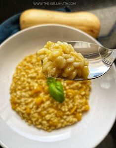 a spoon with some food in it on a plate