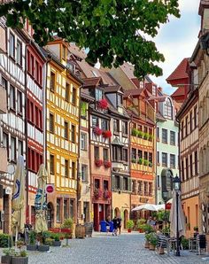 a cobblestone street lined with colorful buildings