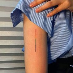 a woman's arm with a small red line on the left side of her leg