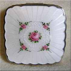 a white plate with pink roses on it