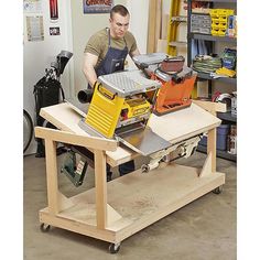 a man working on a workbench in a garage