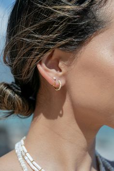 Add the prettiest white fire opal open hoop earrings to sweeten your earlobes. These tiny "claw" hoops are perfect paired with any of our other favorite hoop earrings. ✦ DETAILS ✦✧ Name: Kalino (kah LEE no) - bright one.✧ You will receive 1 pair.✧ Size: 10mm outer diameter; 8.5mm inner diameter.✧ Gold Plated Sterling Silver.✧ 3mm Synthetic White Fire Opals.✧ All Ke Aloha Jewelry pieces come packaged thoughtfully, beautifully, and ready for gift giving. White Hoop Huggie Earrings, Everyday White Huggie Cartilage Earrings, White Tarnish Resistant Small Hoop Huggie Earrings, White Tarnish-resistant Small Hoop Huggie Earrings, Delicate Small Hoop Pierced Earrings, Delicate White Small Hoop Huggie Earrings, Dainty Hoop Pearl Earrings For Pierced Ears, White Dainty Huggie Hoop Earrings, Hypoallergenic White Hoop Cartilage Earrings