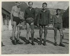 three men with crutches standing next to each other