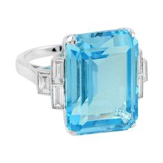 an aqua topazte and diamond ring with baguettes in white gold,