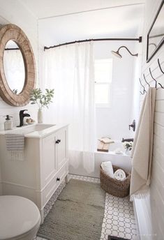 a bathroom with a sink, toilet and mirror