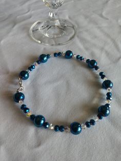 Elegant blue glass bead bracelet with clear sparkling crystals. This beautiful accessory gives glam to any outfit and is sure to make heads turn. The bracelet in photo is 8.5 inches long (can be made to order according to wrist size/circumference). Please feel free to message me! Elegant Adjustable Glass Crystal Bracelet, Blue Crystal Bracelet For Party, Elegant Adjustable Blue Crystal Bracelet, Elegant Blue Stretch Bracelet With Faceted Beads, Elegant Blue Beaded Crystal Bracelet, Elegant Faceted Beads Stretch Bracelet For Party, Party Crystal Bracelets With Spacer Beads, Elegant Beaded Glass Stretch Bracelet, Elegant Beaded Glass Bracelets