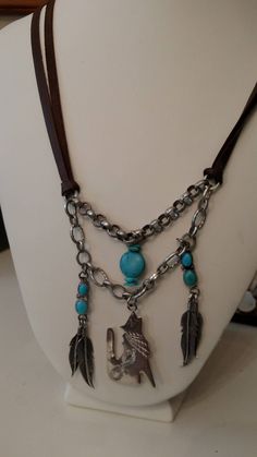 NEW LOWER PRICE Not unlike some of my other pieces, this piece has a southwest vibe. The vintage charms come right out of the desert with the howling coyote and feathers. The brown leather double cord with the accented turquoise beads really makes this piece stand out. Thanks for looking!! Turquoise Concho Bohemian Necklace, Turquoise Bohemian Concho Necklace, Adjustable Bohemian Turquoise Necklace With Lobster Clasp, Adjustable Bohemian Turquoise Necklace, Vintage Handmade Necklace For Western-themed Events, Handmade Vintage Necklace For Western-themed Events, Vintage Concho Necklaces For Festivals, Bohemian Concho Dangle Jewelry, Vintage Concho Necklace For Festival