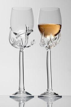 two wine glasses sitting next to each other