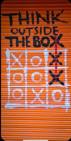 an orange roller door with the words think outside the box written on it in black