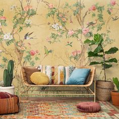 a living room with floral wallpaper and rugs