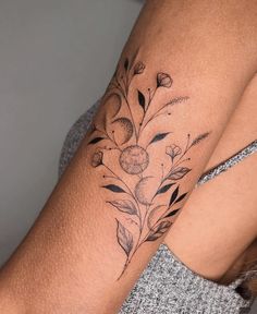 a woman with a flower tattoo on her arm and the bottom half of her arm