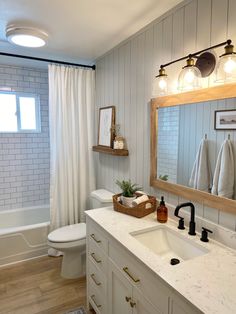 a bathroom with a sink, toilet and bathtub