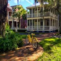 a yellow bike parked in front of a house