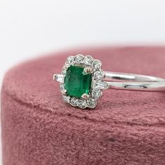 This lovely balanced ring design flaunts a gorgeous Zambian emerald with an incredible grass green hue. It's a great size for a daily accessory and looks stunning seated in a scalloped halo of diamonds, with two tapered baguette diamonds that create a more modern feel. A great piece of jewelry for May babies, and lovers of green and emeralds! This ring is made with solid 14K Gold and natural Earth mined SI / G-H diamonds. As listed, this ring is ready to ship. If you're interested in purchasing Designer Silver Jewellery, Diamond Halo Ring, Jewelry Showcases, Baguette Diamonds, Zambian Emerald, Grass Green, Halo Diamond Ring, Natural Earth, Halo Ring