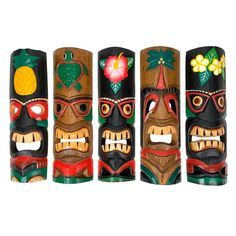 four wooden totems with different designs on them