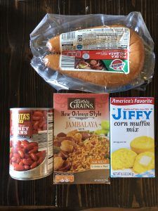 two packages of food sitting on top of a table next to some bread and other items