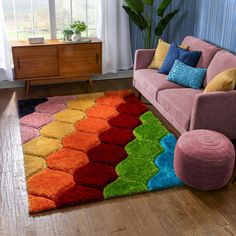 a living room with a pink couch and colorful rug