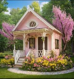 a pink house with flowers in the front yard and steps leading up to it's porch