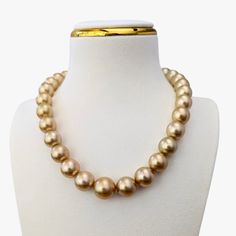 When I first laid eyes on these pearls, I could hardly believe they were real. The pearls before me were so flawless, round, and large, so perfectly uniform in color, overtone, and luster, that I had to check TWICE to be sure.But they are indeed real—and they are truly extraordinary. This stunning necklace features deep gold ("18 karat" color) Golden South Sea pearls, meticulously matched for their remarkable round shape and exquisite size, ranging from 12 to 15.5mm. The necklace is beautifully Formal Pearl Necklace With Polished Beads, Classic Pearl Necklace With Polished Beads, Formal Polished Pearl Necklace, Formal Gold Pearl Necklace With Polished Beads, Classic Gold Pearl Necklace With Round Beads, Formal Pearl Necklace With High Luster, Gold Pearl Necklace With Round Beads For Formal Occasions, Formal Necklaces With Round High Luster Beads, Formal High Luster Round Bead Necklaces