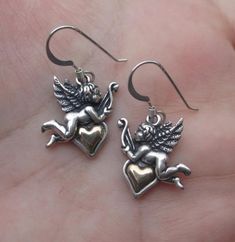 "This sterling silver angel Earrings measure:1-1/4\" from the top of the earwire to the bottom of the angel.Width of the angel at the widest part is almost 3/4\" or 31mm x 18mm The heart is gold filled. Price is for the pair of earrings at $21.95 This Sterling Silver Angel pendant measures: just over 1-1/4\"(from top of the angel to the bottom) x 5/8\" at the widest part. or 33mm x 19mm The heart is gold filled. Price is for one pendant at $18.95" Angelic Sterling Silver Jewelry For Gifts, Silver Angelic Jewelry For Gift, Angelic Silver Jewelry For Gift, Nickel-free Sterling Silver Earrings For Valentine's Day, Wing-shaped Pierced Earrings As Gift, Wing-shaped Earrings For Gift, Wing-shaped Pierced Earrings For Gift, Gold Winged Sterling Silver Jewelry, Symbolic Pierced Earrings For Anniversary