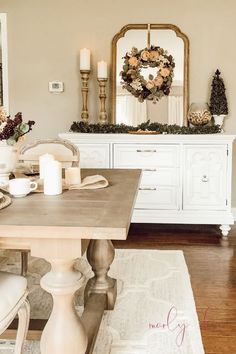 a dining room table with candles and flowers on it