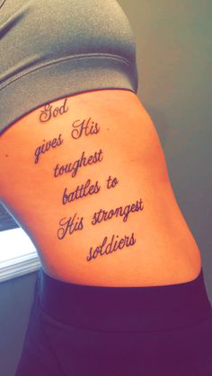 the back of a woman's stomach with a tattoo saying god gives his tough battles to his strong soldiers