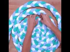 two hands that are on top of a blue and white rope