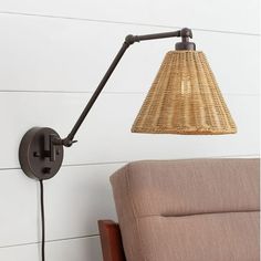 a lamp that is on top of a wall next to a couch in a room