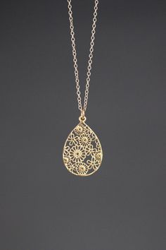 "A beautifully detailed bright 14k gold vermeil filigree teardrop flower charm simply dangles from a 14k gold filled chain. The chain is finished with a 14k gold filled lobster clasp. It is adjustable and can be worn close to the neck at 16\" or a little longer at 18\". This lightweight go-with-everything necklace completes any outfit for daytime or evening. Gold flower charm: 19x29mm Total length of pendant: 1 1/4\" Gold chain: 1.5mm Matching earrings are available... www.etsy.com/listing/52325 Gold Flower Jewelry With Intricate Design, Filigree Drop Jewelry As Gift, Gold Filigree Teardrop Pendant Jewelry, Filigree Drop Jewelry For Gifts, Teardrop Jewelry With Intricate Design For Gifts, Gold Drop Jewelry With Intricate Design, Gold Intricate Drop Jewelry, Elegant Teardrop Jewelry With Flower Charm, Dainty Gold Jewelry With Intricate Design