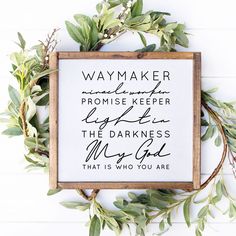 a framed sign with the words, way maker and prove on it next to some green leaves