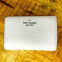 This Beautiful Kate Spade Wallet Is Compact But Holds It All. Doesn’t Look Like It’s Ever Been Used However There’s A Small Ink Mark On The Outside. It May Come Off But I Didn’t Want To Cause Any Damage To Your Wallet. Please See Pics Before Bidding. White Rfid Blocking Wallets For Everyday, White Rfid Blocking Wallets, White Bifold Wallet With Rfid Blocking, White Kate Spade Wallet For Everyday Use, White Kate Spade Bags With Card Slots, White Bifold Coin Purse With Card Slots, White Bifold Wallet For Everyday Use, White Rectangular Kate Spade Wallet, Everyday White Bifold Wallet