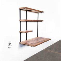 a wooden shelf sitting on the side of a white wall