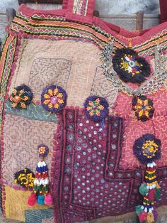 an old purse is decorated with beads and flowers