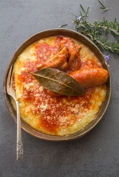 a pan filled with sauce and meat on top of a table