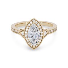 an engagement ring with a pear shaped diamond in the center and pave set shoulders