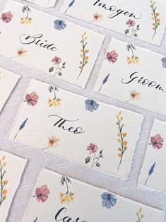 six place cards with flowers on them