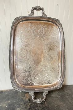 an ornate silver serving tray on a table