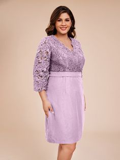 a woman in a purple dress posing for the camera with her hands on her hips