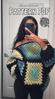 a woman taking a selfie in front of a door wearing a crocheted sweater