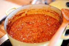 a pot filled with sauce sitting on top of a stove