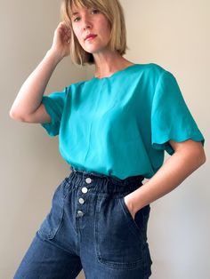 "⚡️ minimal teal boxy fit top with scalloped edges and scoop neckline. shoulder pads for shape. made by SaraStephen. 100% polyester. ⚡️ size M (modeled on size small, 5'5\") ⚡️ shoulders 16.5\" chest 21.5\" length 23.5\" sleeve length 9\" ------------------------------------------------------------------------------------------- Please message questions prior to purchase. Once shipped, sales are final, no return/exchange. But please contact me if you have any problems with your order. Please see Chic Turquoise Tops, Chic Green Crew Neck Blouse, Chic Green Scoop Neck Top, Minimal Blouse, Teal Blouse, Boxy Top, Scalloped Edges, Scalloped Edge, Workout Tops